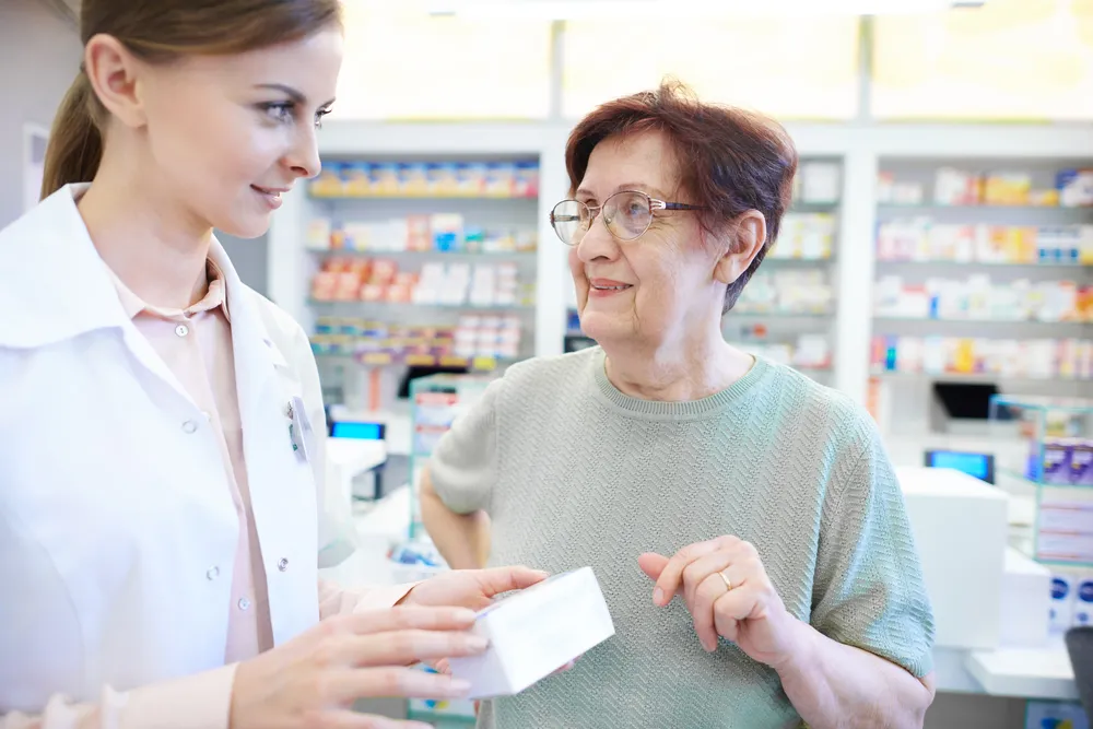 female-pharmacist-assisting-senior-woman
