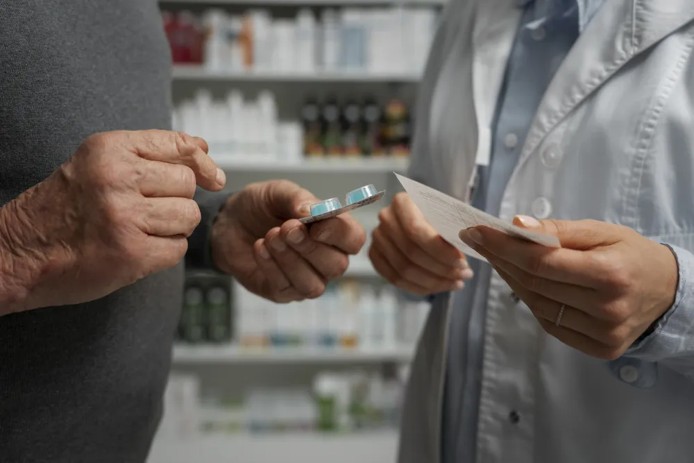 senior-man-consulting-female-pharmacist-medication